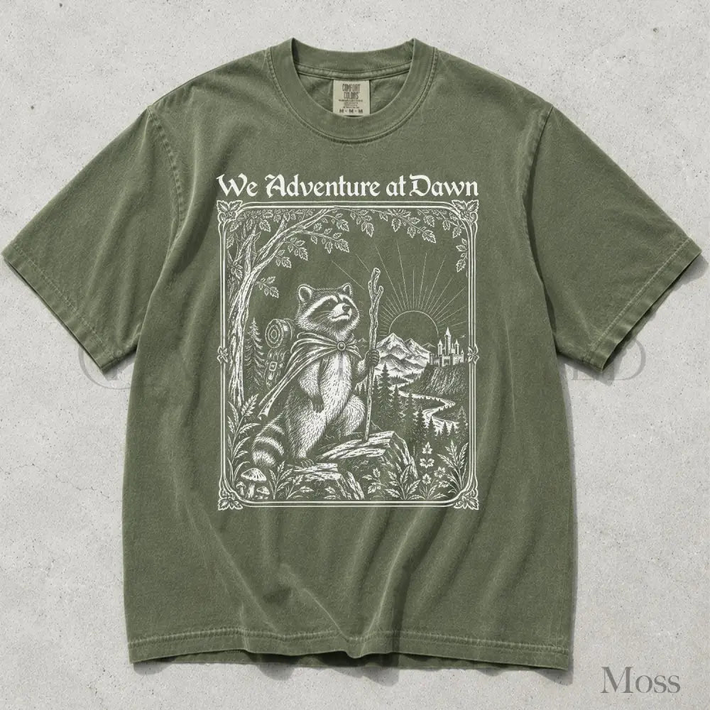 We Adventure at Dawn Hiking Raccoon Comfort Colors T-Shirt - Moss / S - T-Shirt