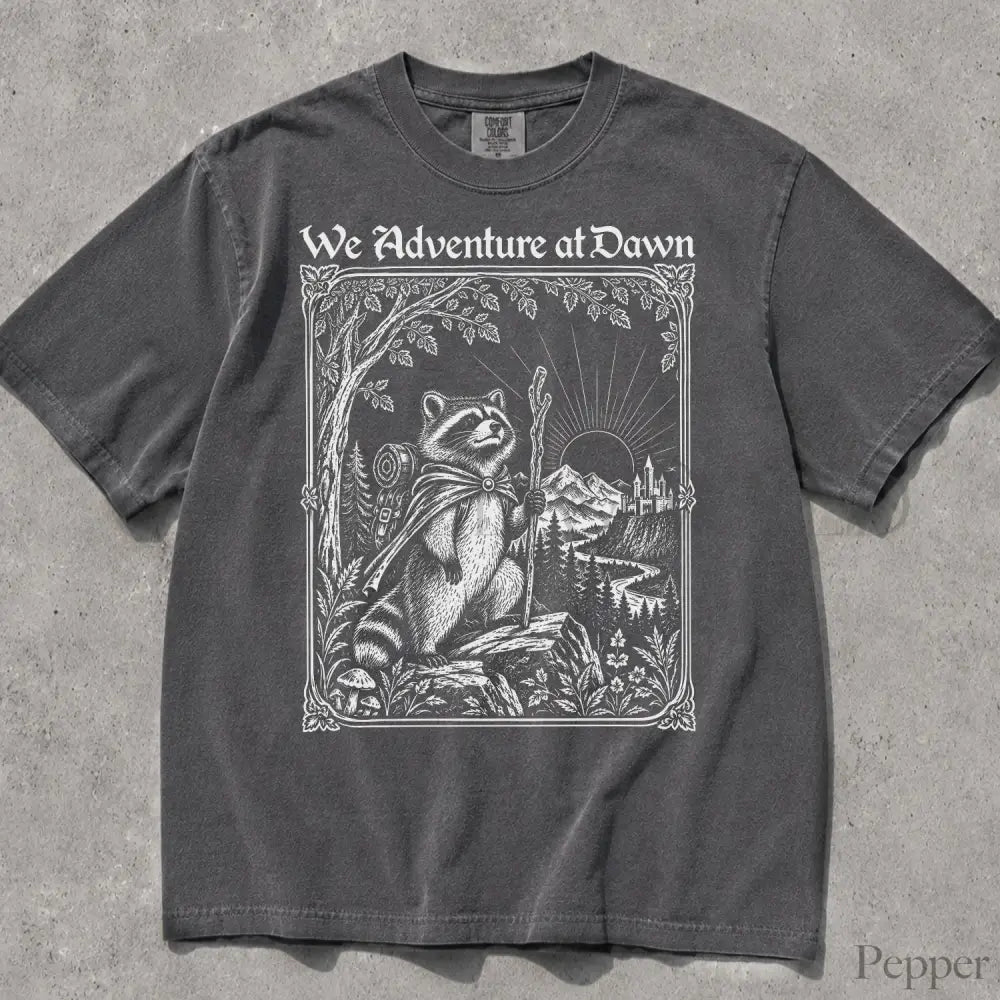 We Adventure at Dawn Hiking Raccoon Comfort Colors T-Shirt - Pepper / S - T-Shirt